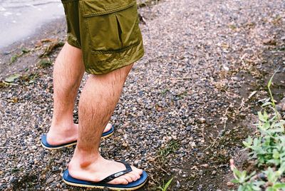 Low section of man standing on ground