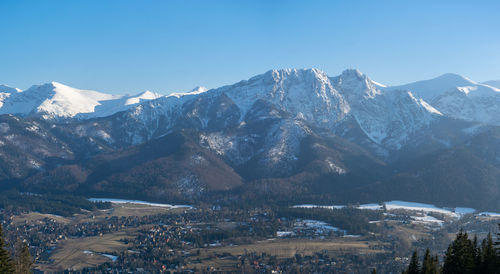 Scenic view of snowcapped mountains against clear sky