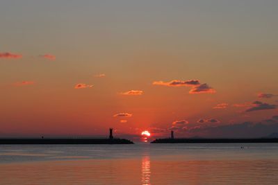 Scenic view of sea against romantic sky at sunset