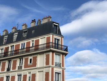 Low angle view of building against cloudy sky