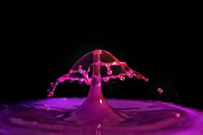 Close-up of water splashing against black background