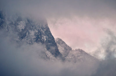 Low angle view of snowcapped mountains against sky