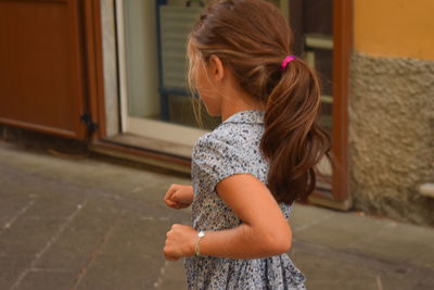 Rear view of girl running outdoors