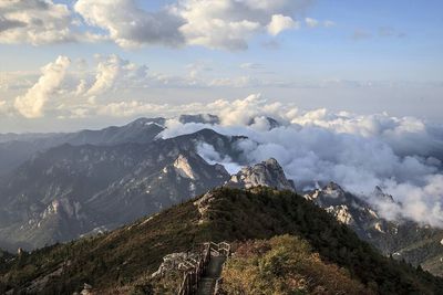 Scenic view of mountains against cloudy sky