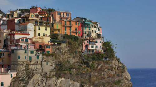 Buildings in city against clear sky