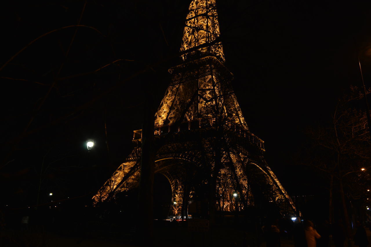 night, illuminated, low angle view, arts culture and entertainment, amusement park, sky, amusement park ride, glowing, built structure, tree, ferris wheel, lighting equipment, celebration, long exposure, outdoors, travel destinations, dark, architecture, light - natural phenomenon, motion