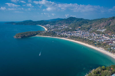 High angle view of sea and cityscape against sky