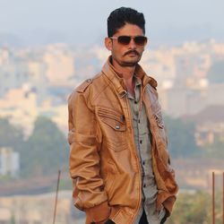 Portrait of young man wearing sunglasses while standing outdoors