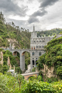 View of bridge over river against cloudy sky