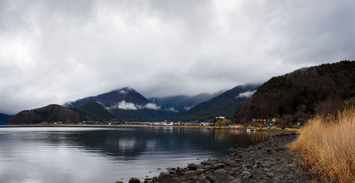 Scenic view of lake and mountains against sky