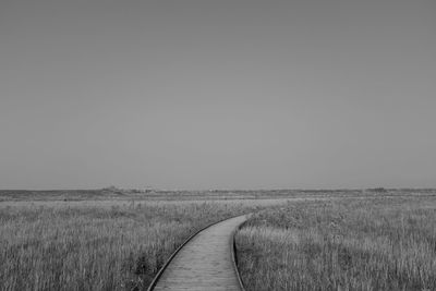 Scenic view of agricultural field against clear sky