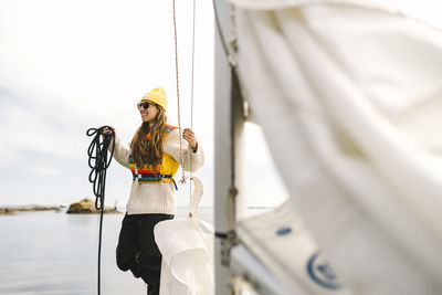 Woman holding rope on boat