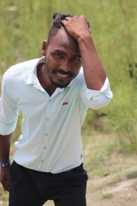 Portrait of smiling young man standing outdoors