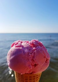 Close-up of ice cream in sea against clear sky