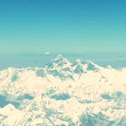 Scenic view of snow covered mountains against sky