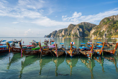 Boats moored in sea against sky