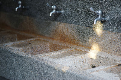 High angle view of water flowing from faucet