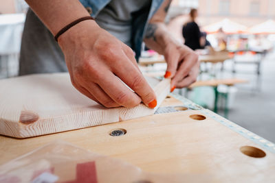 Midsection of woman working at carpentry workshop