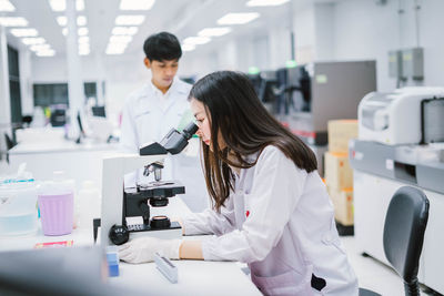 Scientist examining specimen in laboratory