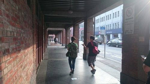 Full length of woman standing by railing