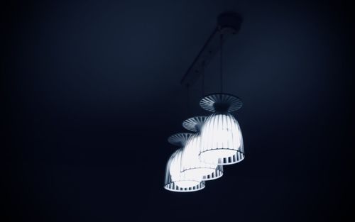 Low angle view of illuminated light against black background