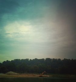 Scenic view of lake against cloudy sky