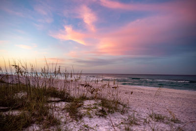 Scenic view of beach against sky during sunset