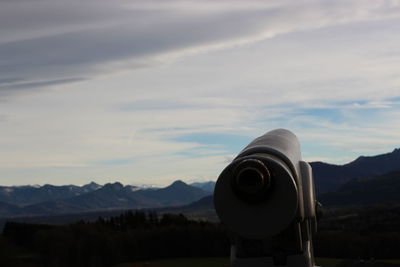 Coin-operated binoculars against mountain range