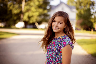 Portrait of smiling girl standing outdoors