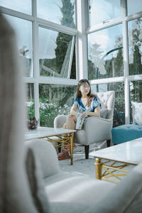 Woman sitting on chair in building