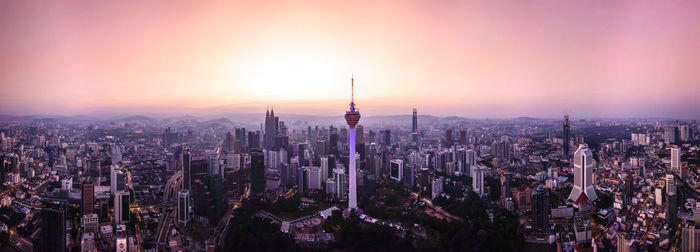 Panoramic view of city against sky during sunset