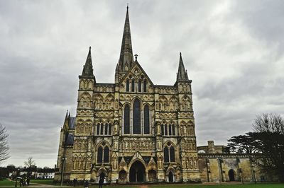 Low angle view of building against cloudy sky