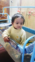 Cute boy sitting on sofa