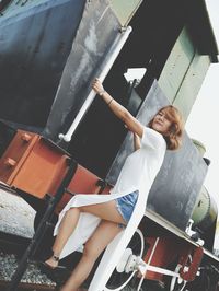 Tilt shot of woman climbing on train