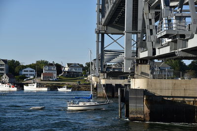 Boats in river with buildings in background