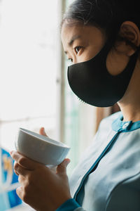 Close-up portrait of woman using mobile phone