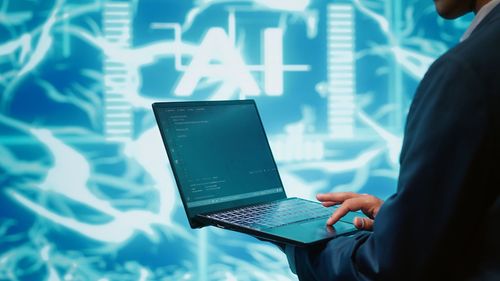 Midsection of businessman using laptop