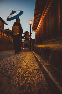 Rear view of man walking on railway station platform