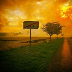 Scenic view of field against sky at sunset