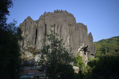 Low angle view of rocks against clear sky