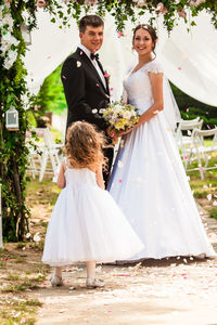 Bride and bridegroom standing in traditional clothing