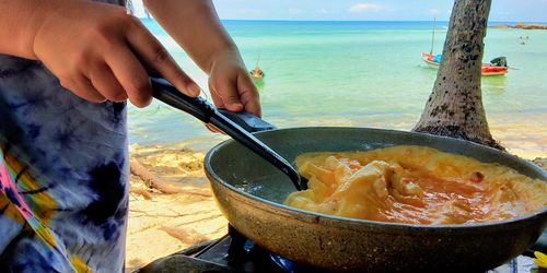 Midsection of man preparing food at beach