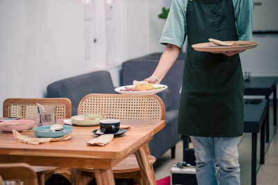 Midsection of man preparing food