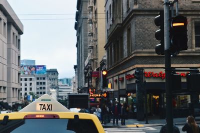 City street and buildings against sky