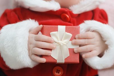 Close-up of baby holding christmas present