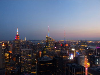 Illuminated cityscape against clear sky