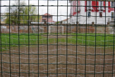 Close-up of soccer field seen through fence