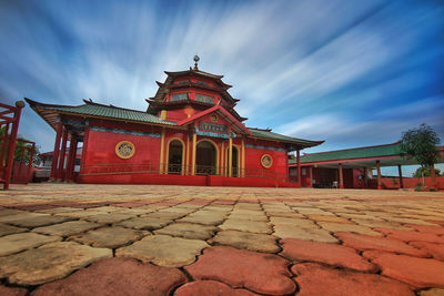 View of temple building against cloudy sky