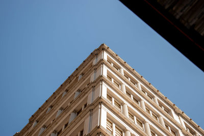 Low angle view of building against clear blue sky