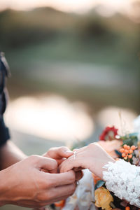 Midsection of couple holding hands